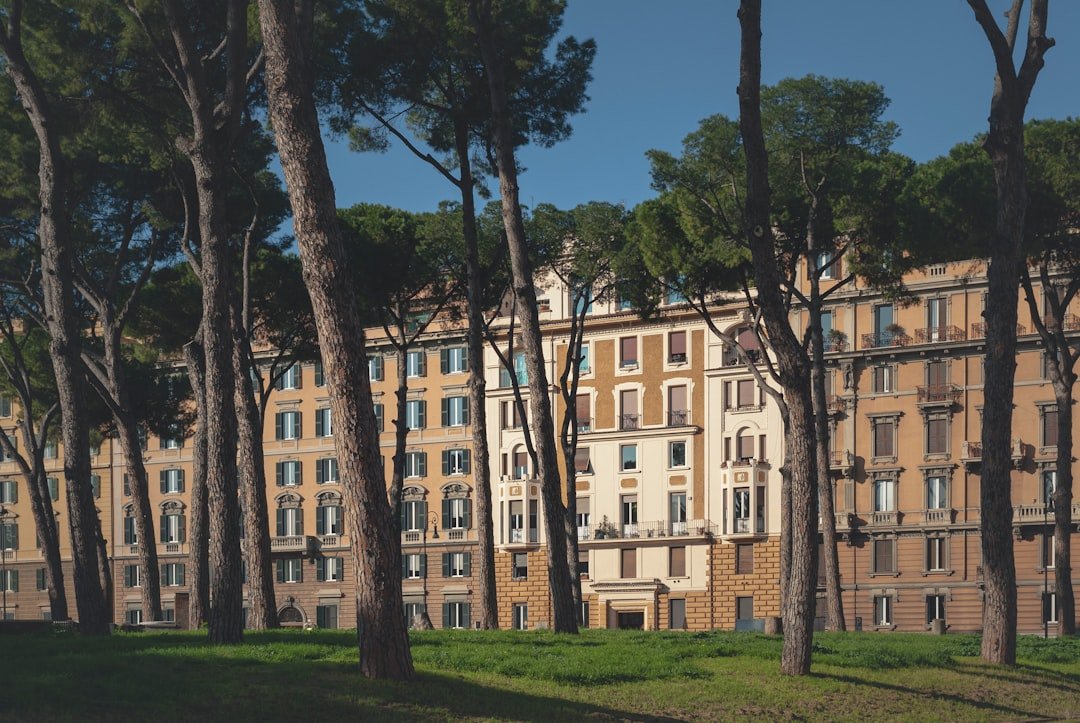 brown concrete building near green trees during daytime