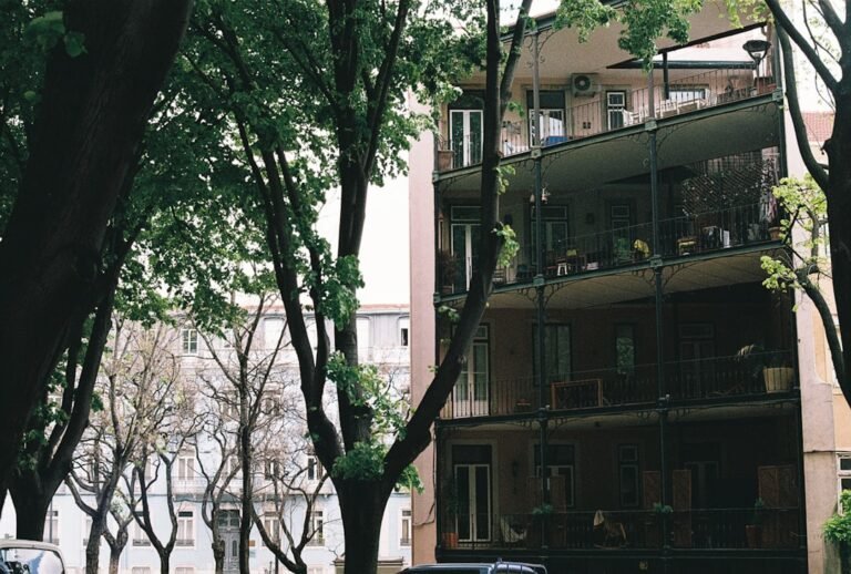 a car parked in front of a tall building
