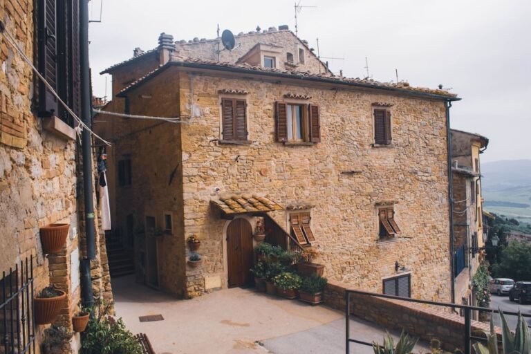 Traditional italian stone house with wooden shutters.